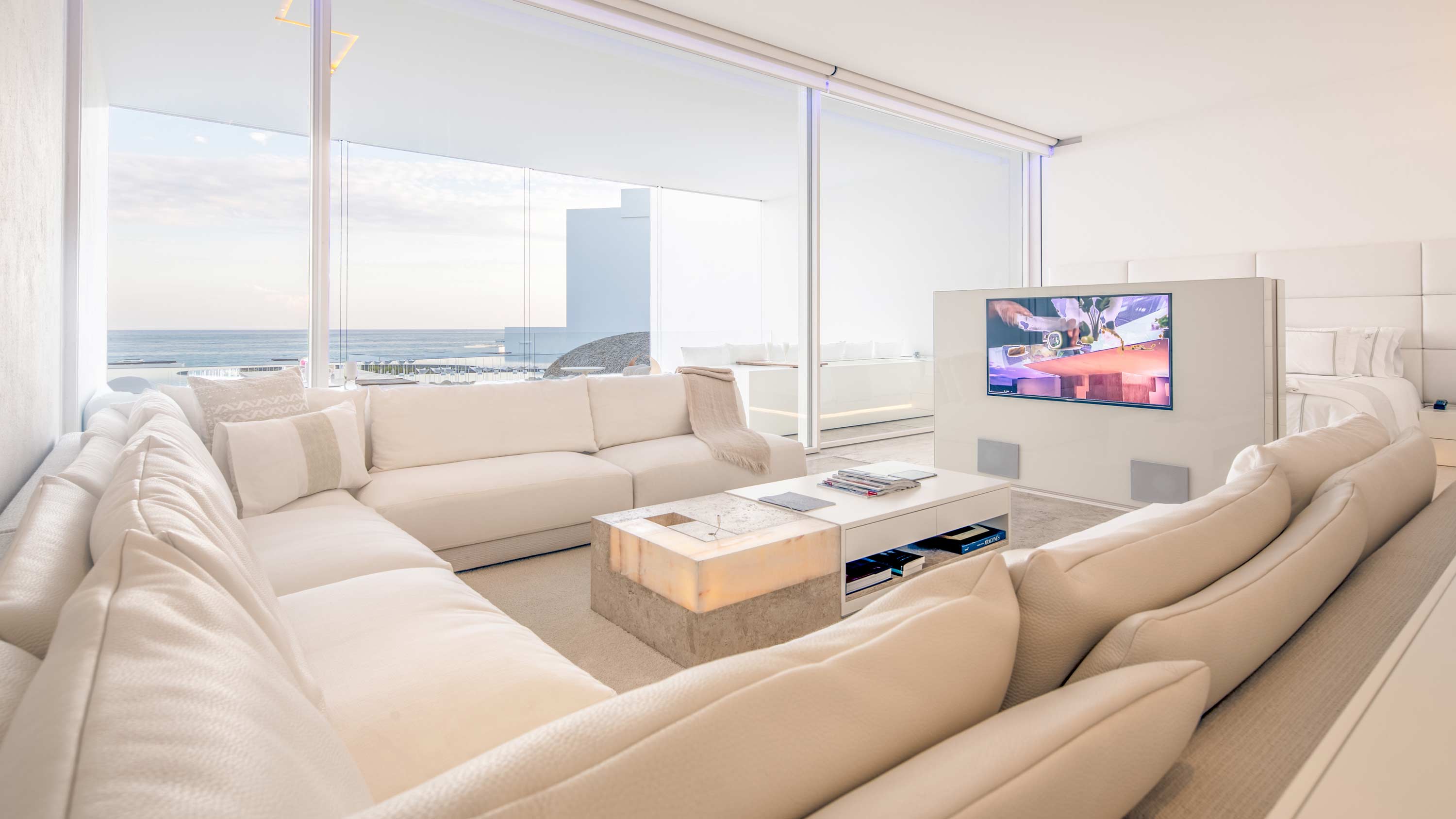 condo residence with large windows and white furniture and walls