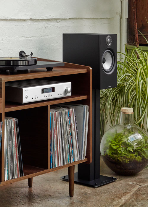 A turntable, receiver, and floor-standing speaker with vinyl