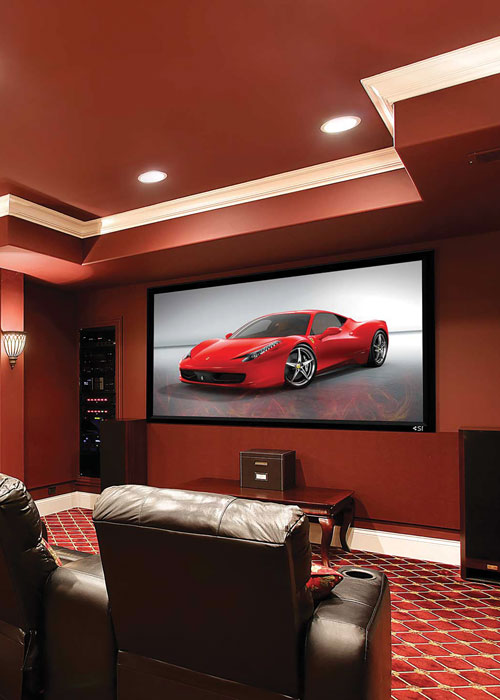 A home theater with red walls and carpeting.