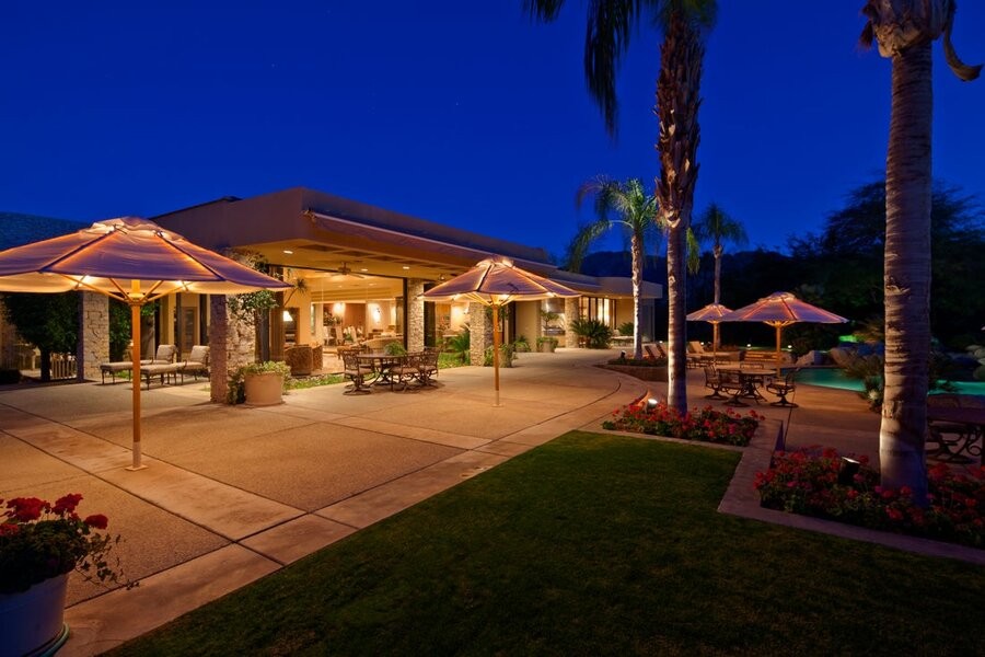 A home’s exterior illuminated by landscape lighting.