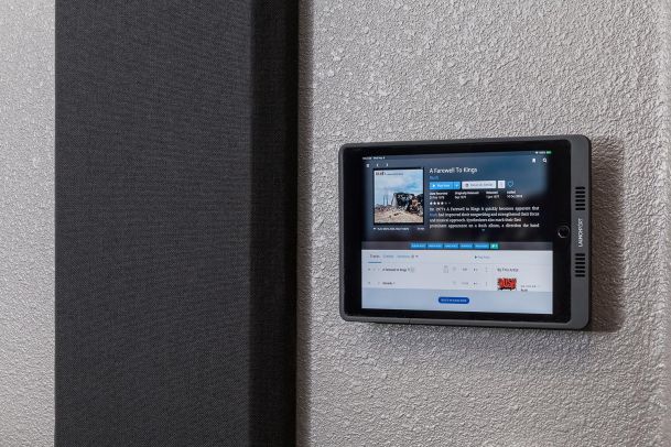 Wall-mounted touchscreen panel displaying music album details