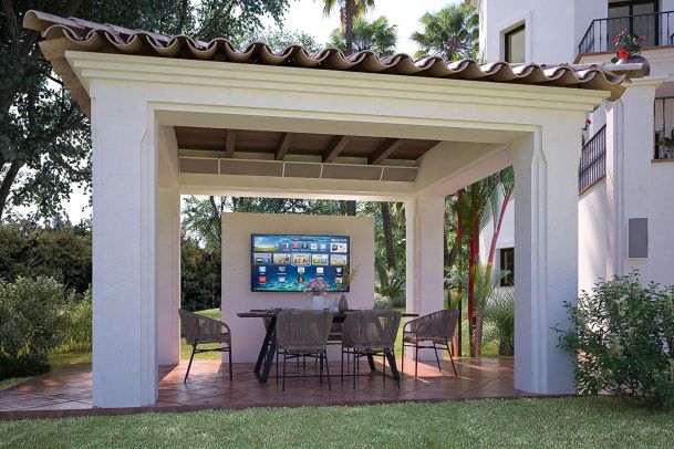 Outdoor covered patio with dining table and wall-mounted TV