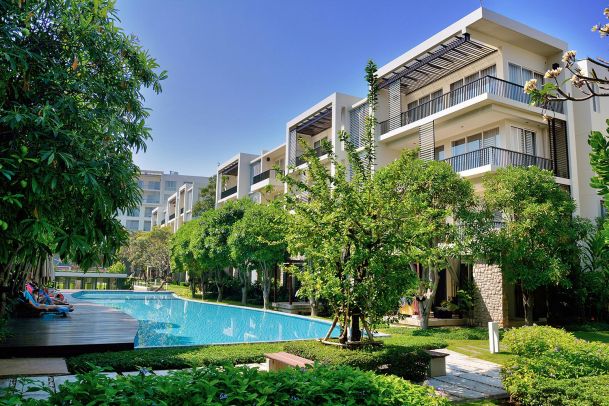 Luxury apartment complex with swimming pool and landscaped garden