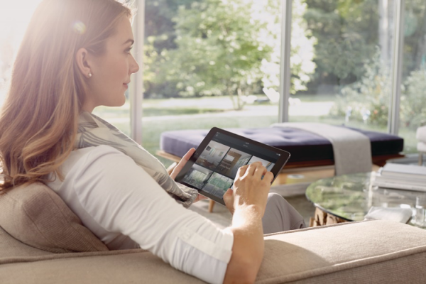 Woman using a home automation platform on her tablet.